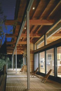 A long cedar porch blurs the houses southern edge, in contrast to the closed face on the north side, where cedar boxes contain the baths and pantry.