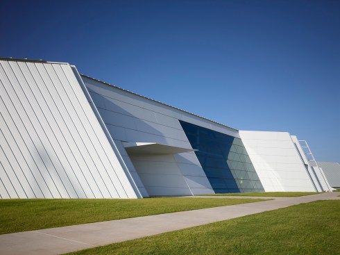 The north façade includes the main building entry and the boat storage entry.  The sloping façade suggests movement, ripples, and the flow of water.  
