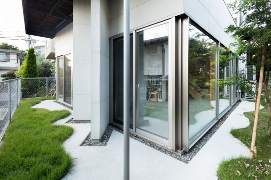 South facade on ground floor. Concrete and green space overlap
