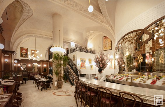 INTERIOR/
The floors throughout the space are a retrospective of Art Nouveau organic, plant forms, taking inspiration from the masters of Art Nouveau like Victor Horta and Antoni Gaudi. An intricate half inch mosaic tile flooring, similar to the arcade, is prevalent at the entrance and the south side of the restaurant, while the north side is an ornamented wood oak marquetry floor. All indoor lighting and chandeliers are designed in the same style as the exterior arcade lighting, displaying a reinterpretation of organic forms.