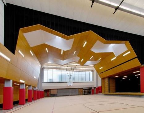 Exeter Schools Multipurpose Space - Exeter, Missouri The challenge was to design a single space that functions as a cafeteria, practice gym and performance hall for a rural K-12 school district on a budget. The solution is a simple steel frame structure inserted into an existing courtyard with an outer layer of tectum and an inner layer of perforated wood panels.
Architect: Dake Wells Architecture