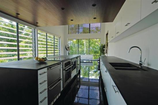 Operable louvers shade the kitchen while letting daylight into the space. 