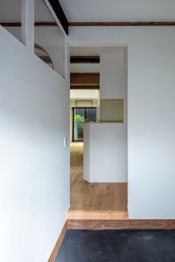 Entryway view. The downstairs open floor plan makes the rear courtyard garden (tsuboniwa) viewable from the entryway. 