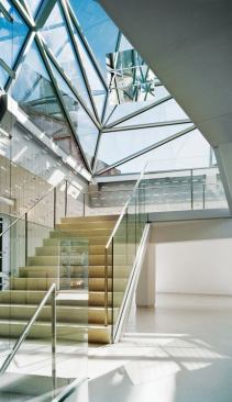 A heliostat at the top of the stair gathers sunlight ...