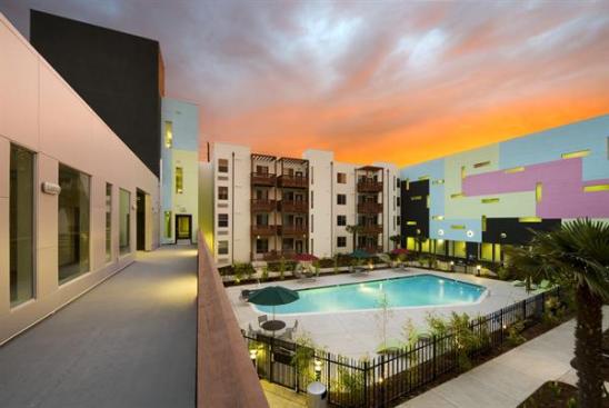 The pastel-colored Tetris pattern on the walls of the communal space helps enliven the pool area.