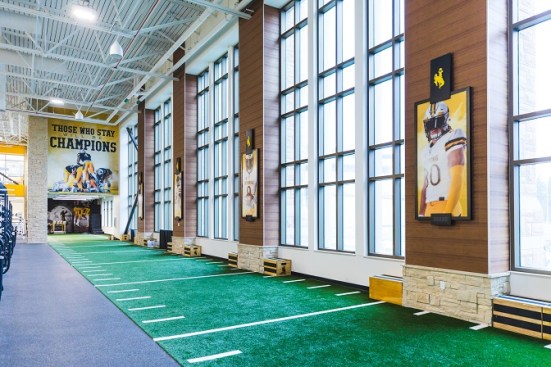 Graphics adorning the indoor training turf point to the team’s culture and mantras
