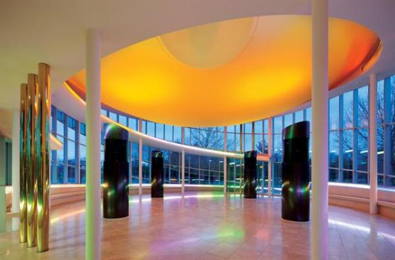 One of the largest new program elements is a new reception venue, which features an orange, inverted-dome ceiling plane and bronze-clad air trees that provide ventilation to allow a 600-person occupancy.