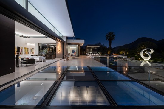 Serenity Indian Wells modern resort style home opens sliding glass walls for indoor outdoor living