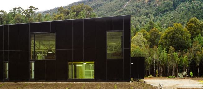 Cutouts from the fa&ccedil;ade allow outward views to the waterfall.