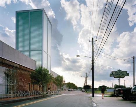 The tower rises from grade on the building?s north side and is composed of individual interlocking structural glass channels. Each glass channel is held in place with mechanical clips and then sealed with clear silicone.