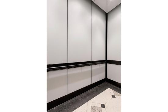 LEVELe-105 Elevator Interior with main panels in ViviChrome Chromis glass with White interlayer and Opalex finish; handrail panels in Fused Graphite with Sandstone finish; Round Handrails in Oil-Rubbed Bronze at the Brandywine Building, Wilmington, Delaware