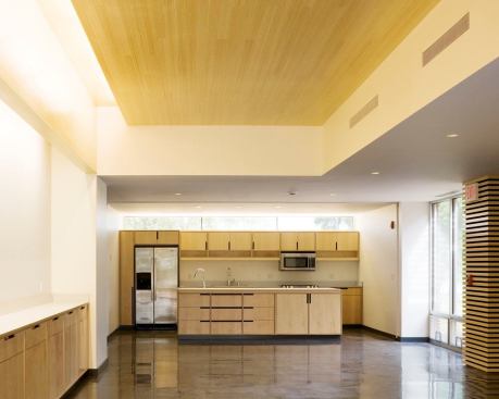 The lobby supports informal gatherings as well as a kitchen alcove and storage needs. Linear fluorescent coves are incorporated into the ceiling perimeter to provide additional ambient light.