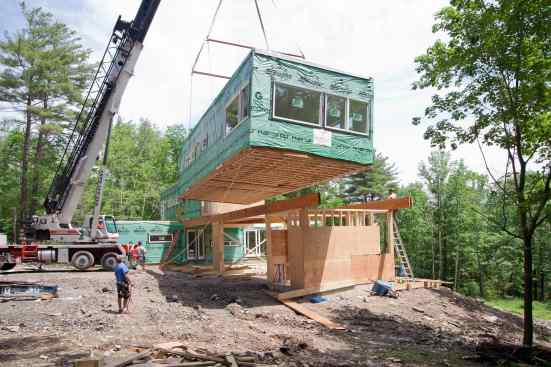 Prefab modules being set by crane.