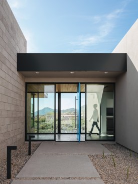 The entry of the home connects the foyer, garage entry and access to the guest area all through the glass ‘bridge’ element.  All access to the home crosses through this space.