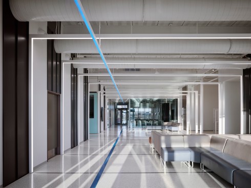 The entry lobby penetrates the building east and west, pulling light through the space. LED light portals activate movement and add energy while soft movable furniture allows for comfortable study and social space.