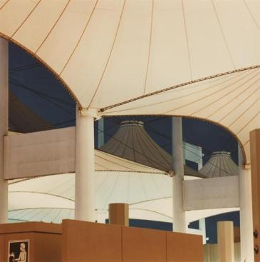 Teflon-coated fiberglass fabric canopies attach to the 147-foot-tall masts.