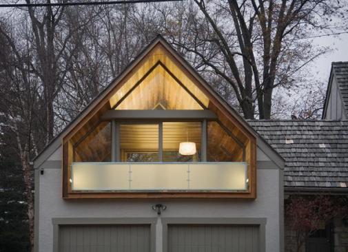 The playrooms wooden tube, clad in 100 year old sinker cypress, is extruded to create a balcony.