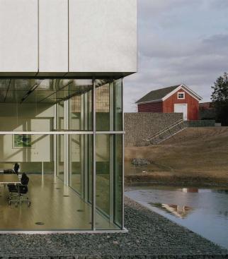 A lower-level conference room looks onto a retention pond on the south side of the site.