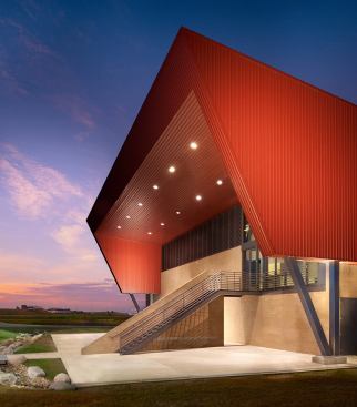 Boulder Regional Fire Training Facilities- Boulder, CO The 18,000-square-foot metal building is adjacent to the publically accessible Boulder Reservoir in Boulder County. The facility consists of a 10 acre fire training center including an administration building, burn building, drill tower and various training props. The sloping wedge form of the building rises from the bermed site perimeter to enclose higher volume spaces and second level classroom / observation hub, creating an iconic agrarian form respectful of its rural context. 
Architect: Roth + Sheppard Architects/TCA Architecture Planning