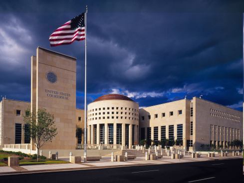 U.S. Courthouse-Laredo, TX The design for this new 148,000-square-foot federal courthouse draws on regional heritage as well as classic architectural elements to make a bold statement in the context of Laredo's existing civic architecture. To accommodate stringent security guidelines, the internal public spaces have all been oriented toward the building's rotunda and landscaped plaza, which also eases way-finding throughout the building. Three separate circulation systems were required: public, defendants in custody, and a private zone for judges, juries, and staff. The three functional elements are expressed as discrete forms. A long, narrow wing along the north houses office areas and optimizes sunlight; court spaces are in a three-story structure defining the east edge; and the entry lobby, including screening functions, is housed in a rotunda at the intersection of these two wings. Simple yet powerful monumental forms, elegantly detailed, express the permanence and dignity of the United States courts. 
Architect: HDR Architecture