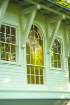 Salvaged materials, such as this Palladian church window, mix&nbsp;with new design features to create a modern space with nostalgic touches.