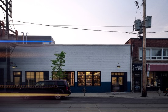 The masonry structure was originally built as a grocery store in the 1940s; new windows and a storefront lend transparency to the façade.