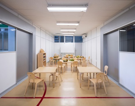 The brightly colored "classroom buildings", in their most basic iteration, serve as three traditional teaching spaces.