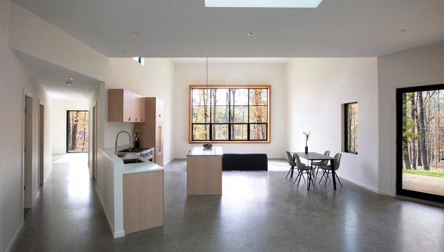 Upon entry, the home unveils an open atrium houses the sunken living room, kitchen, and dining areas.
