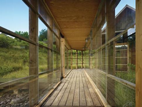 Window-lined walkways link the home's three separate buildings.