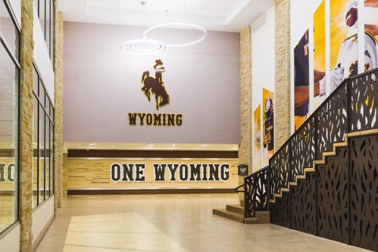 The beautifully designed lobby inside of the Wyoming Rochelle Athletic Center features custom brand components and a donor recognition wall