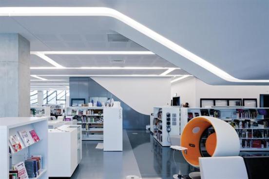 The+multimedia+library+is+filled+with+low+stacks+that+allow+views+out+through+the+aluminum+louver-covered+windows.