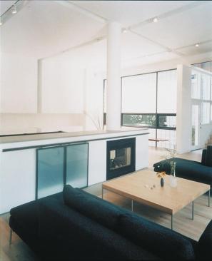 Inside, rolling screens hide a television, but can also be drawn over the two-sided fireplace.