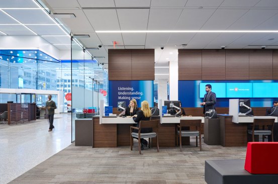 A view of the teller area. A row of LED linear fixtures in the ceiling provides illumination to the desks below.