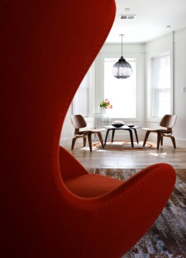 Strategically placed furniture with bold accents help to liven the space that could only really use neutrals for the walls.