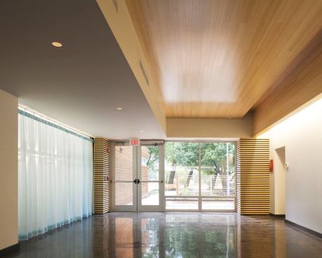 View of the entry area. Linear fluorescent coves are incorporated within the architectural perimeter providing both task and general illumination. MR16 flush-mounted downlights provide dimmable low-level luminance for special functions.