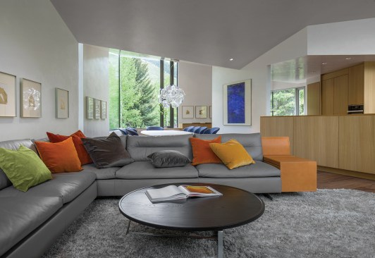 Much of the second floor&nbsp;is open-plan, featuring a living area, dining area (seen beyond), and kitchen.