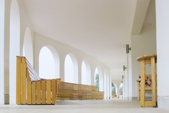 Seating areas in the colonnade along the west façade feature locally made furniture and are spaced such that family groups can have privacy, or socialize together.