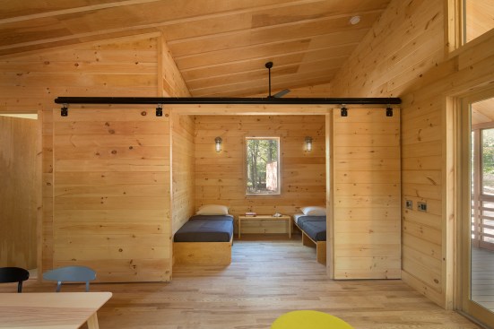 A sliding door in the two-bedroom model separates a bedroom from the living area at night and opens to allow more space and daylight during the day.