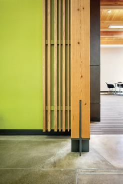 Hennebery Eddy specified structure-as-finish detailing for columns and beams and used standard platform wood framing (nailed studs) behind painted gypsum wallboard or western hemlock 1x boards.