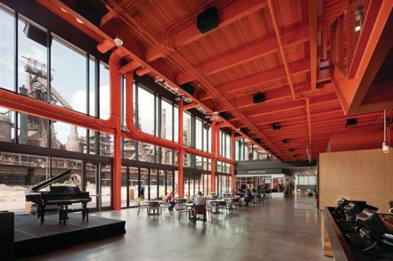 Along the window wall in the lobby is a commons space where visitors browse the gift shop or wait for a showing in one of the building's two movie theaters.