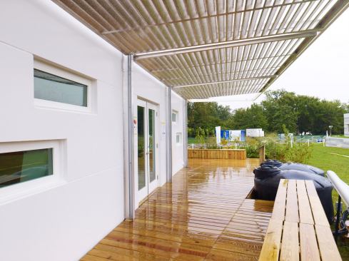 Hinged, aluminum, louvered panels provide privacy and full-perimeter shading, and were designed as a prototype to protect against hurricane-force winds.