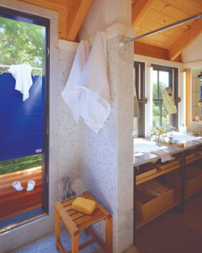 A glass door from the shower of this Falmouth, Mass., master suite (left top) leads to the outdoor shower, a stainless steel "shark cage."