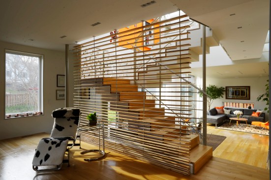 The wood-slat screen by the staircase is made from the wood of a dying silver maple tree in the home's front yard.&nbsp;