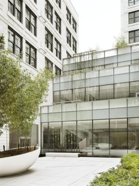 Long-span additions step up from the second-floor courtyard