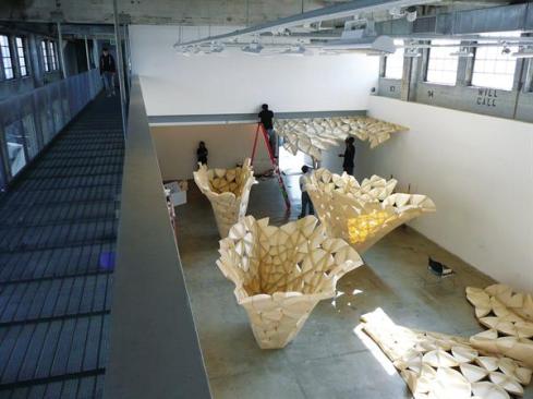Students helped to construct the individual petals and then the actual structure. A team of students is seen working to install some of the perimeter petal sections.