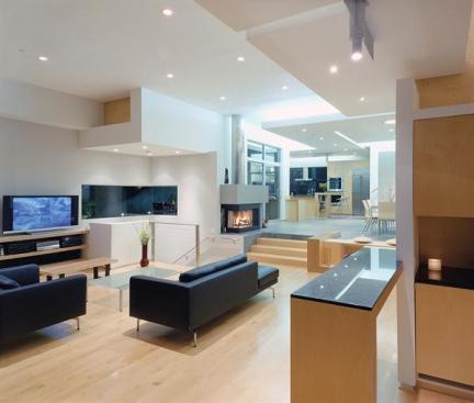 Touches of wood show up on both the exterior elevation and inside Ivo Venkovs hill hugging house. Outside, stationary fir louvers help moderate the suns impact on the house. Inside, Canadian maple floors and built ins made from birch plywood help warm u