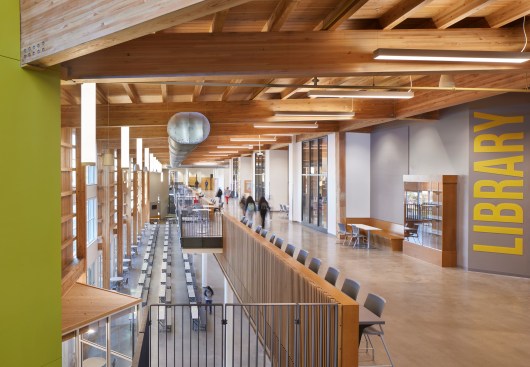 
The commons feature timber framing with glue-laminated columns and beams, wood decking, and purlins for a biophilic approach that reduces embodied carbon.
