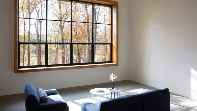 A custom 10' by 14' steel window is strategically elevated to frame the treetops, wetlands,
and distant mountain panorama.