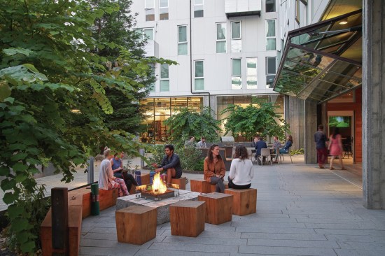 855 Brannan, by David Baker Architects,  in San Francisco, is a  LEED Platinum mixed-use community interweaves high-density homes, open space, and public passages to maximize housing, repair the urban fabric, and activate the edges of an underutilized city block. Shown here, is he Redwood Court Town Hall terrace in the evening.