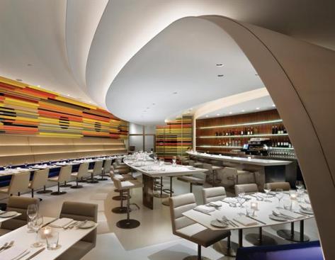 Cascading walls lead down to comfortable banquettes.